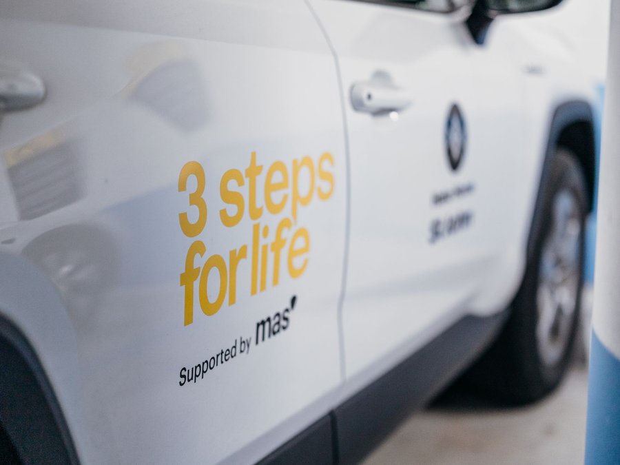 3 Steps for Life logo on side of white car