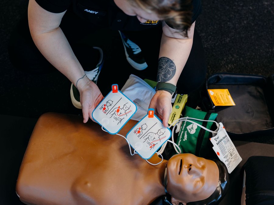 3 steps for life instructor preparing defibrillator pads on a CPR dummy