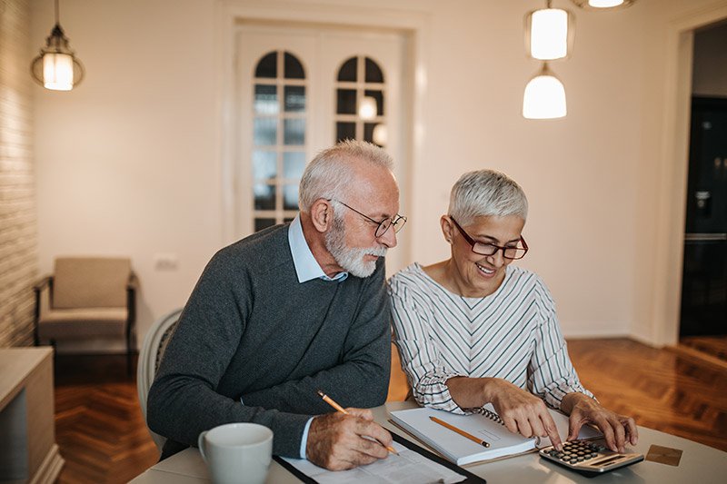 A couple sit down to work out their insurances