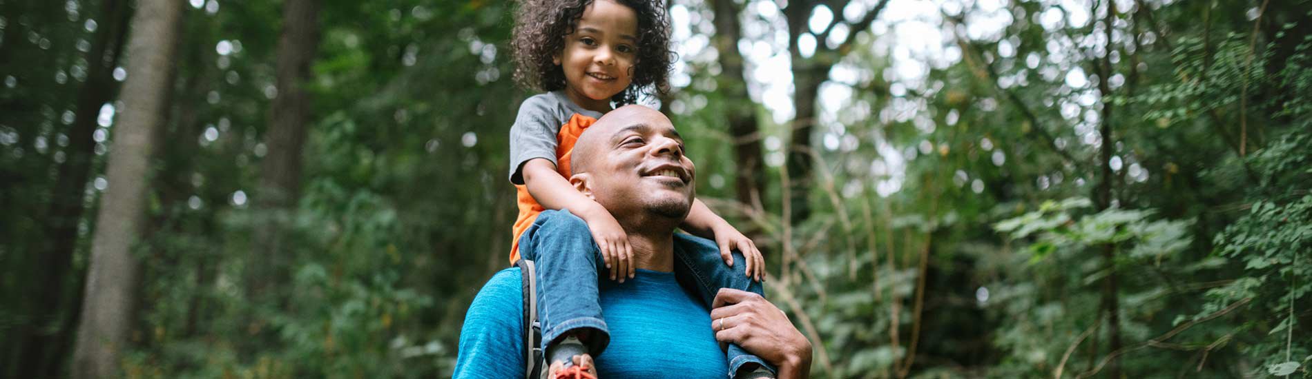 A father hiking carrying his child