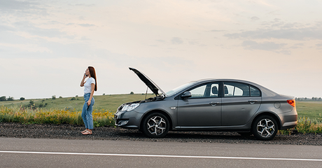 A woman calling roadside assistance after a car break down - social