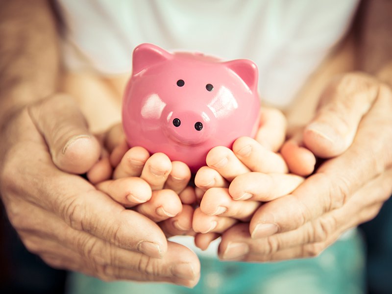 Family holding piggy bank