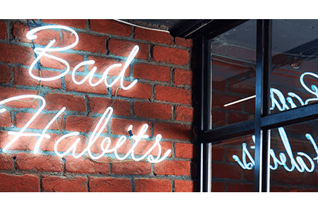 Bad-habits-light-image-on-brick-wall