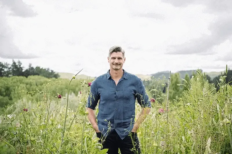 Ben Warren standing in field of flowers
