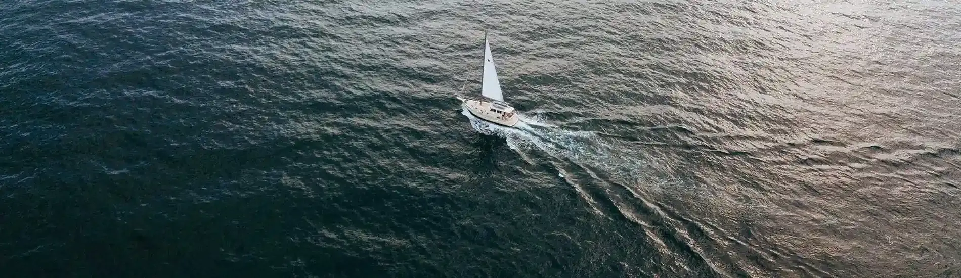 Aerial perspective of a sail boat on the water