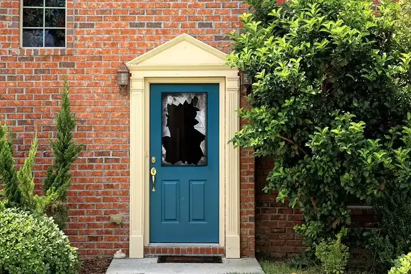 Broken window in a front door of a home