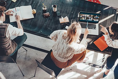 Team of business staff in office on video call