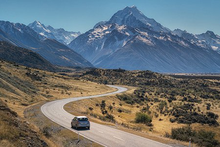 Driving a car on a windy road in New Zealand