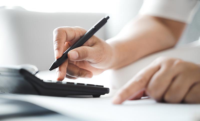 Close up of person using a calculator