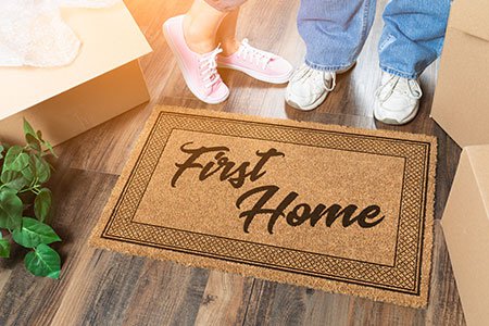Couples-feet-standing-next-to-first-home-doormat.jpg