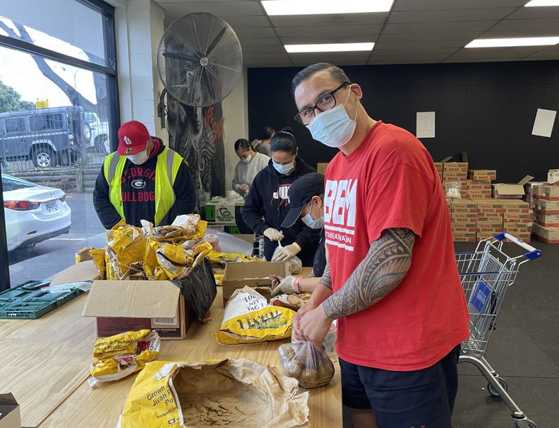 Dave Letele and colleagues packing food boxes