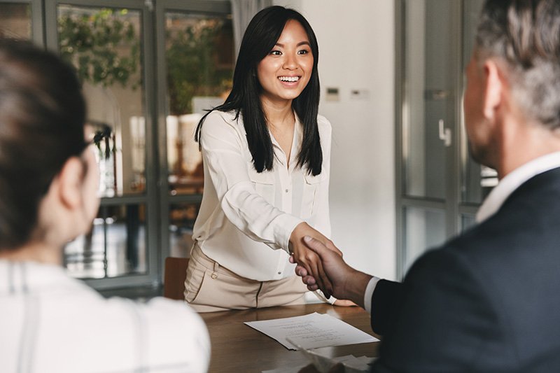 Employees shaking hands after a successful job interview