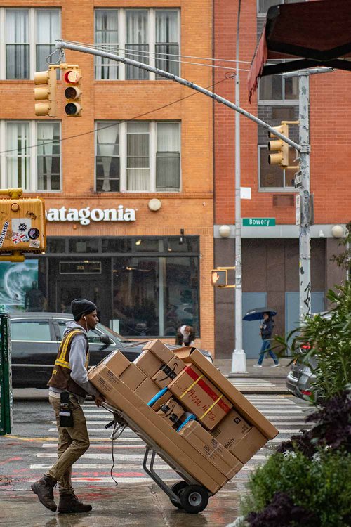 Guy-transporting-parcels-in-front-of-Patagonia-shop-by-Wynand-Van-Poortvlie-on-Unsplash.jpg