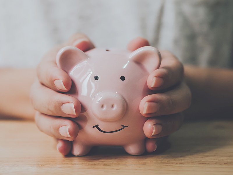 Hands holding a piggy bank