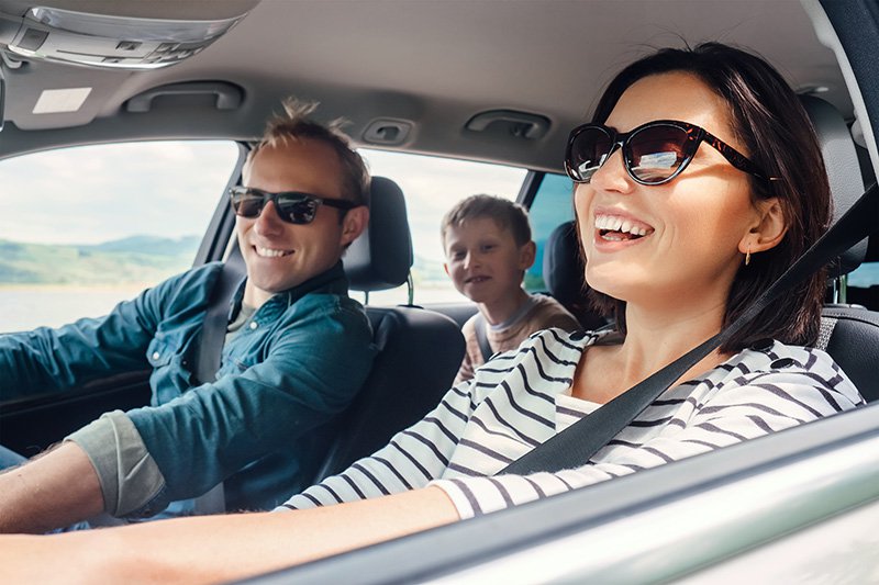 Happy family driving in a car