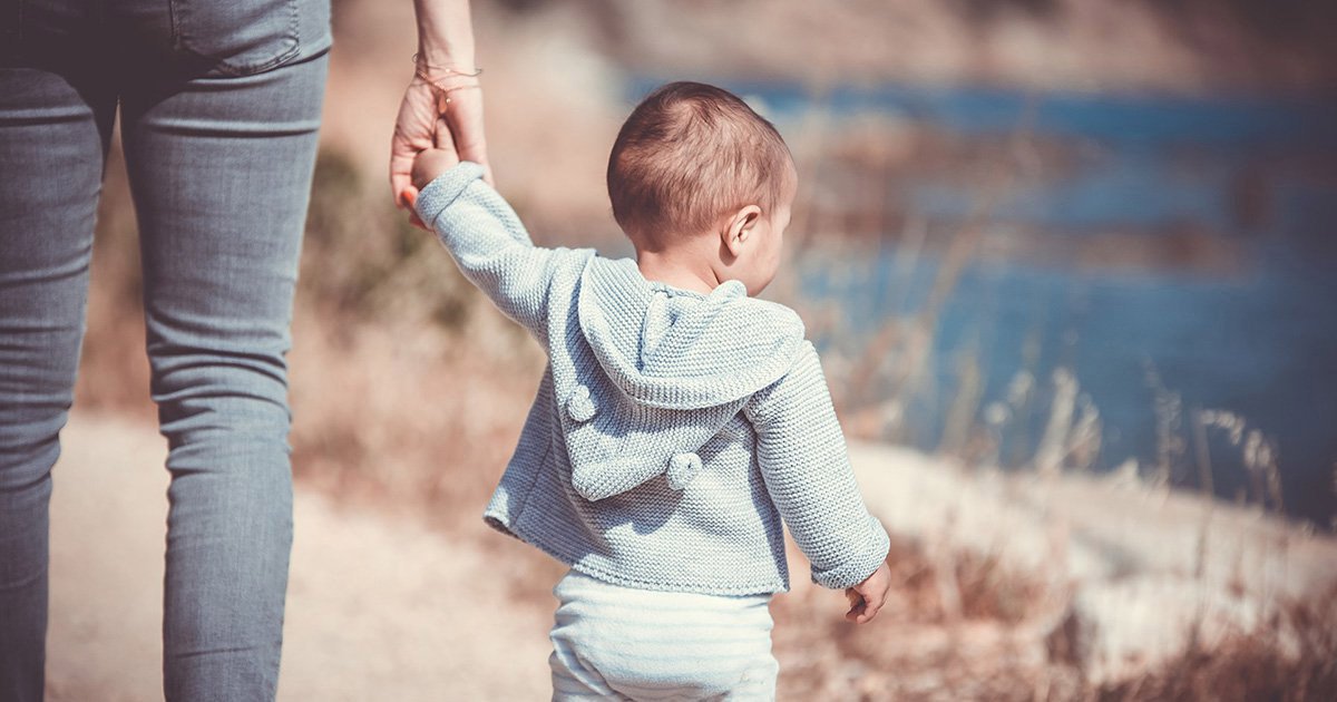 Mum holding childs hand