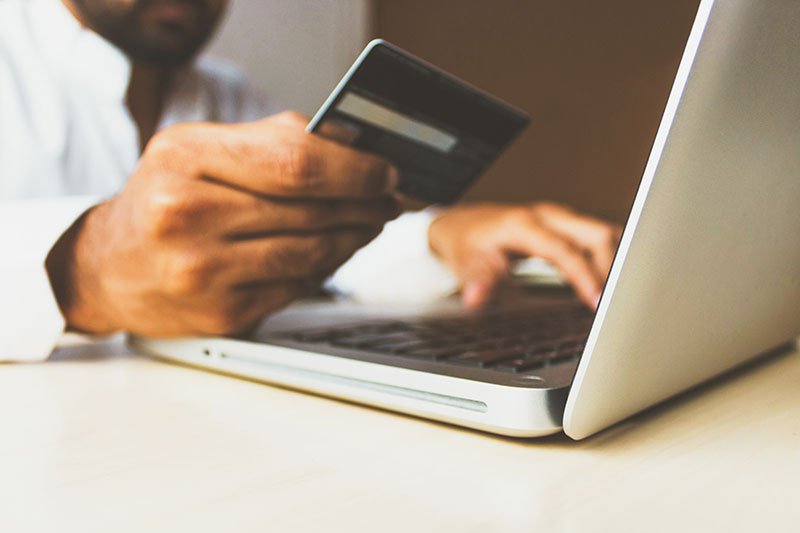 Man making an online payment on his laptop with her credit card