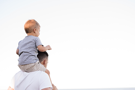 Man holding a child on his shoulders