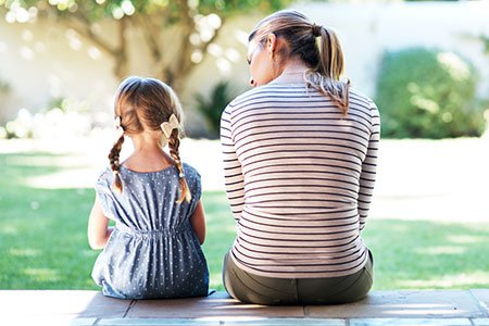 Mother and daughter sitting outside having a conversation