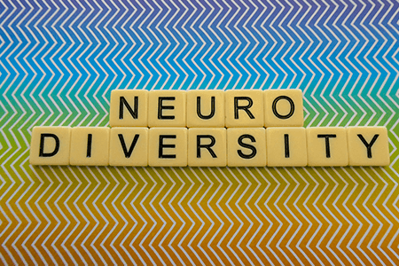 Neurodiversity-spelt-in-scrabble-letters-with-rainbow-zig-zag-background-listing