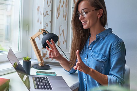 Woman at computer using sign language