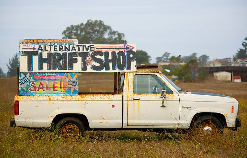 Old car with sale sign on back