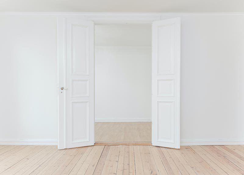 Open doors in a white room