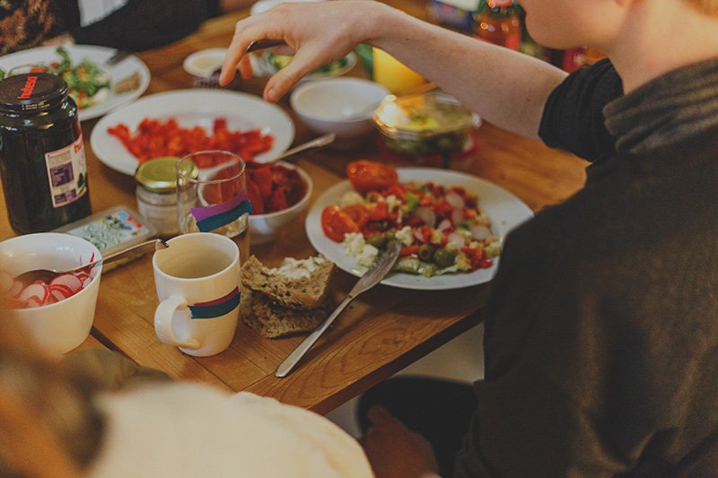 Person eating food at a flat dinner