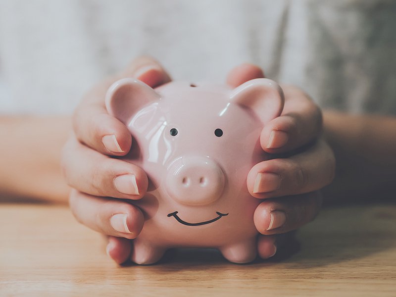 Hands holding a piggy bank