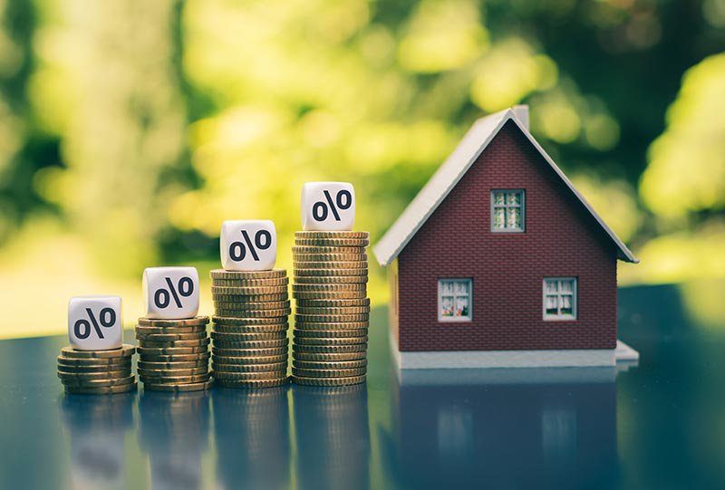 Piles of coins representing savings towards a house