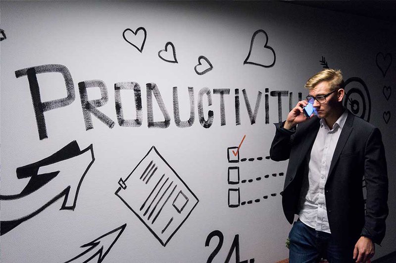 Productivity-men-on-the-phone-in-front-of-wall-art-by-Andreas-Klassen-on-Unsplash.jpg