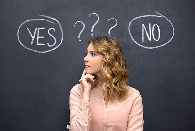 Puzzled woman choosing between yes no