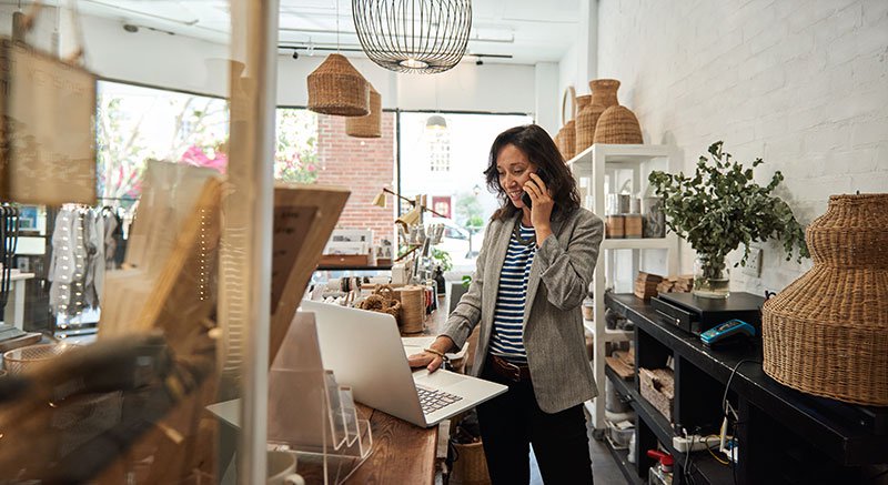 Smiling business owner in her store