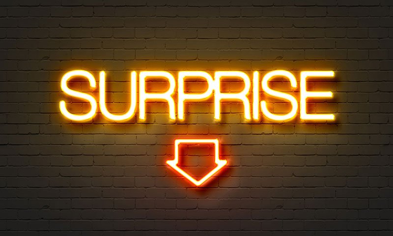 Surprise neon sign on brick wall background