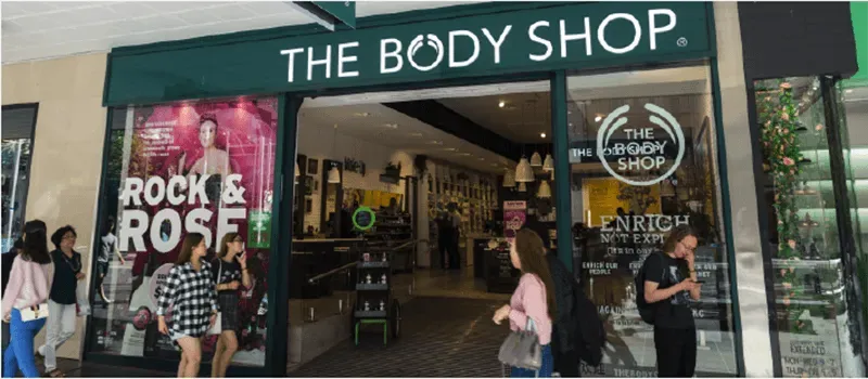 Shopfront image of The Body Shop with shoppers walking past outside