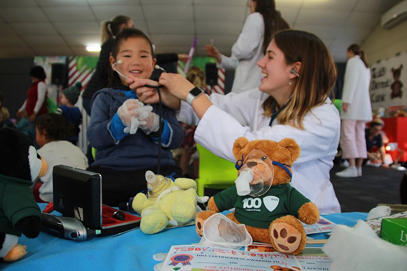 University of Otago student with young child at the ninth annual Teddy Bear Hospital