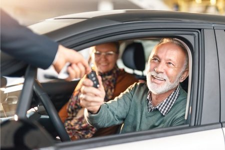 Man getting keys to new car