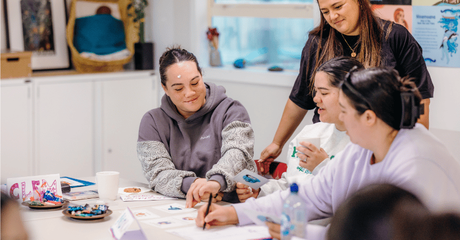 Young Māori women collaborating on some art