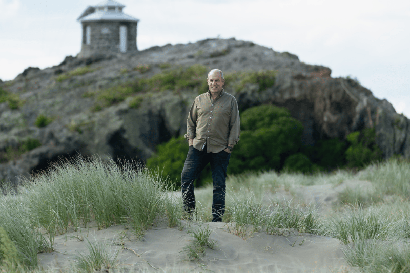 Dr Lacey standing in some sand dunes