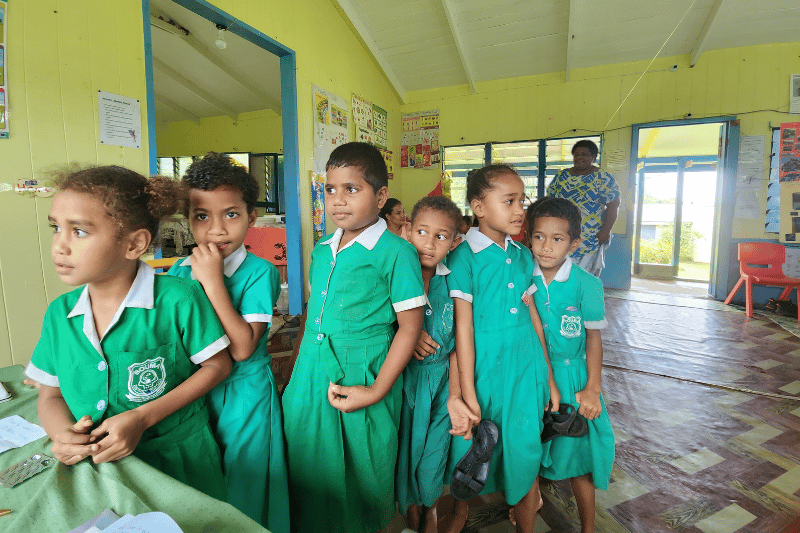 Fijian kids lining up in a school
