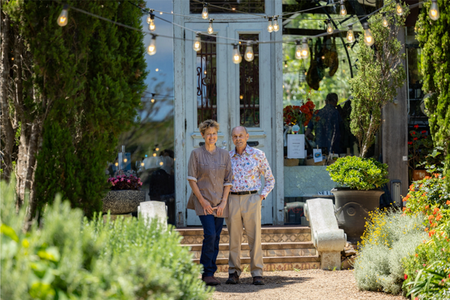 Barnett Bond and Cat Vosper standing at the entrance to their restaurant