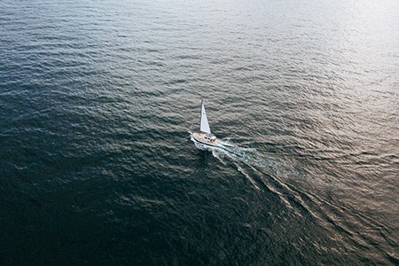 Aerial perspective of a sail boat on the water