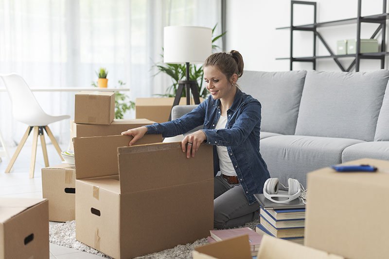 Woman unpacking boxes in her new apartment