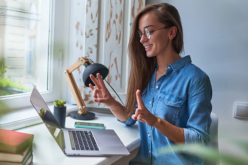 Woman at computer using sign language