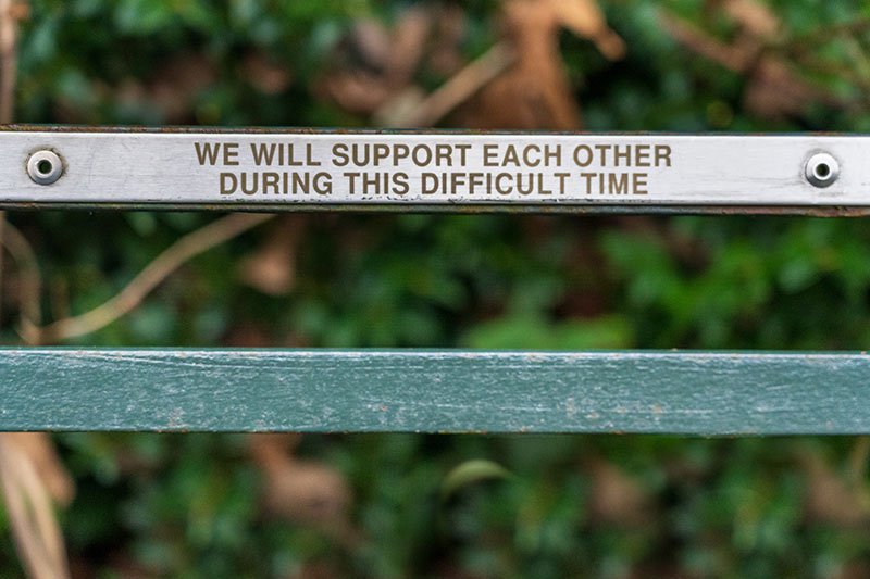Words of support engraved on a park bench