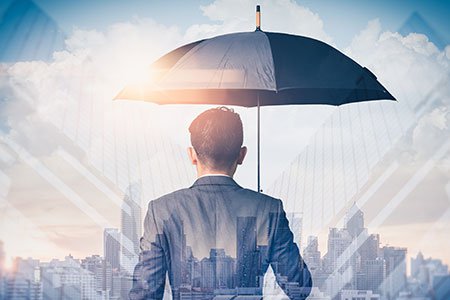 businessman-holding-an-umbrella-for-protection.jpg