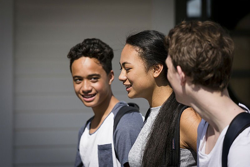 diverse teenages walking happily