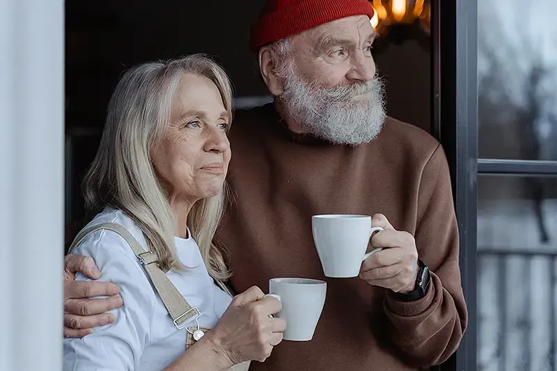 elderly retired couple with mugs