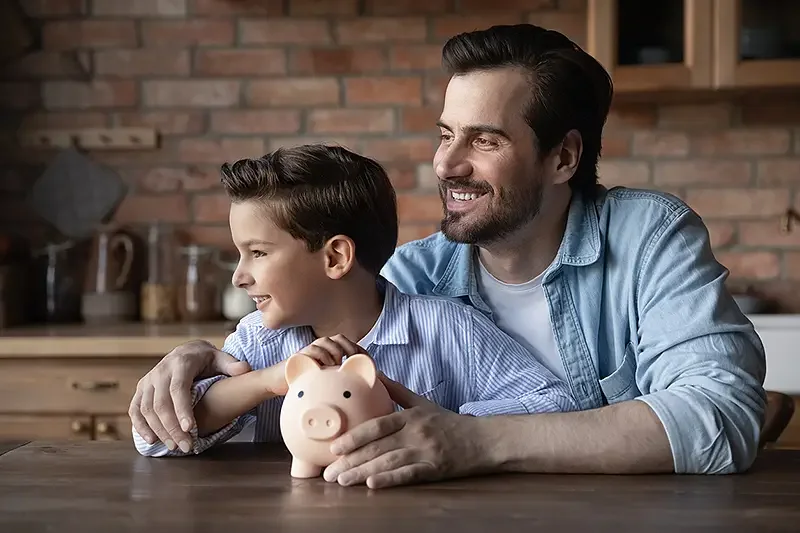 father with son piggy bank