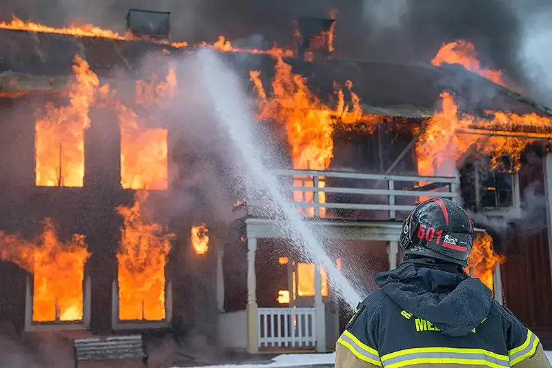 fireman putting a house fire out